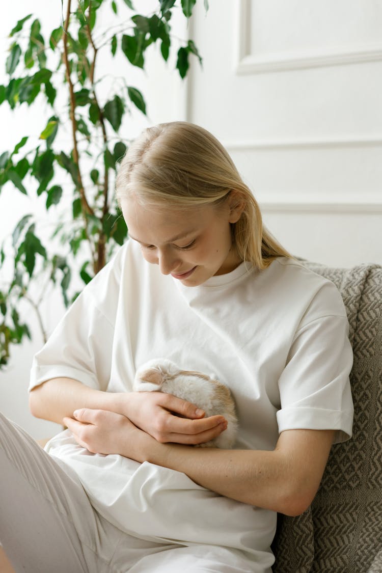 Woman Playing With A Pet Rabbit