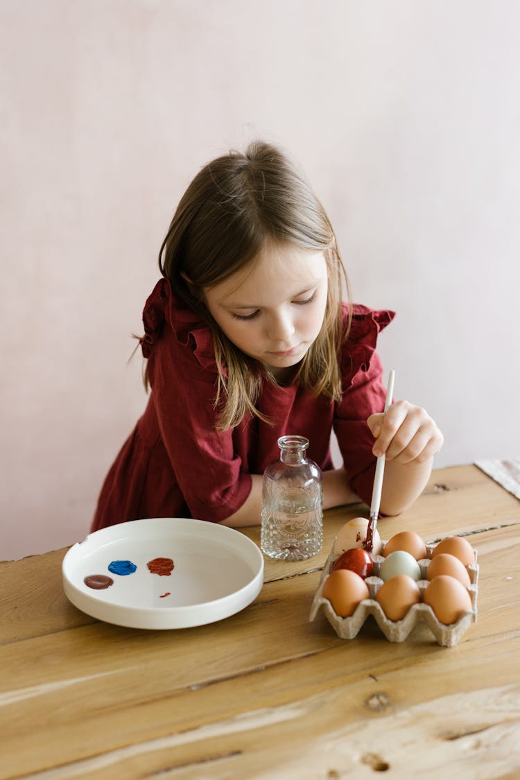 Young Girl Painting The Eggs