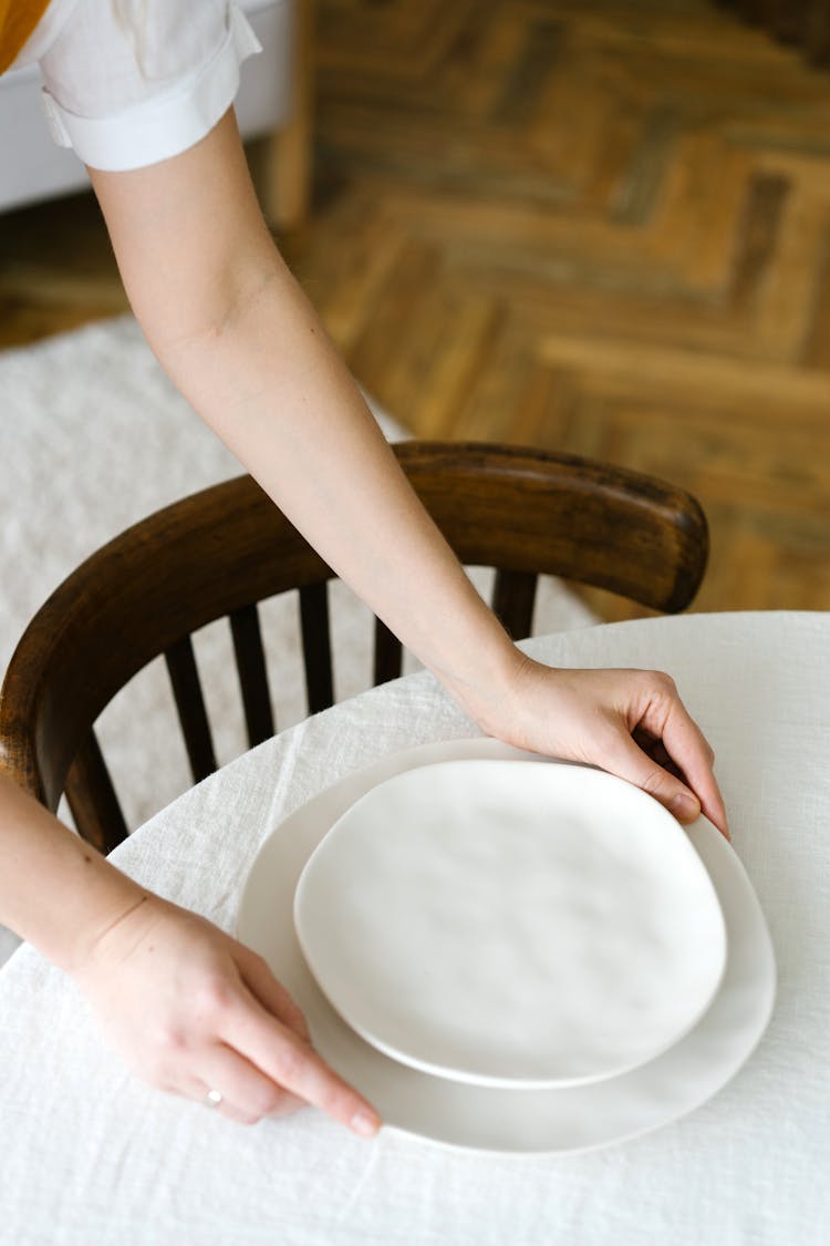 Putting White Plates On A Table