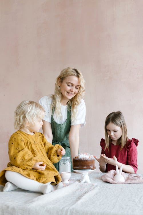 Mother and Daughters making Cakes for Easter Celebration 