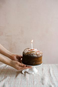 Delightful homemade cake with a lit candle, perfect for celebratory occasions.