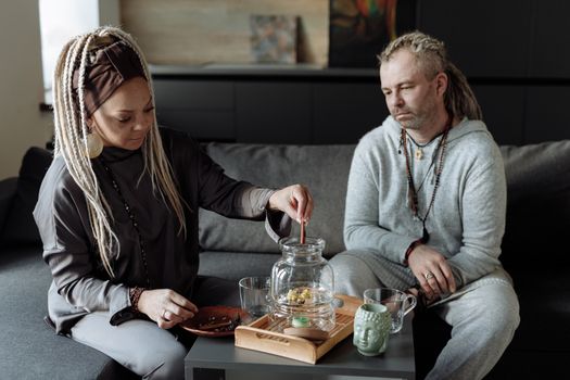 A man and woman sharing a peaceful tea ceremony at home, promoting mindfulness and relaxation.