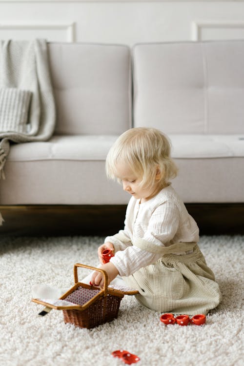 Toddler Sitting on Carpet While Playing