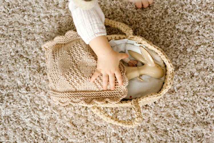 A Rabbit Figurine On Brown Woven Basket