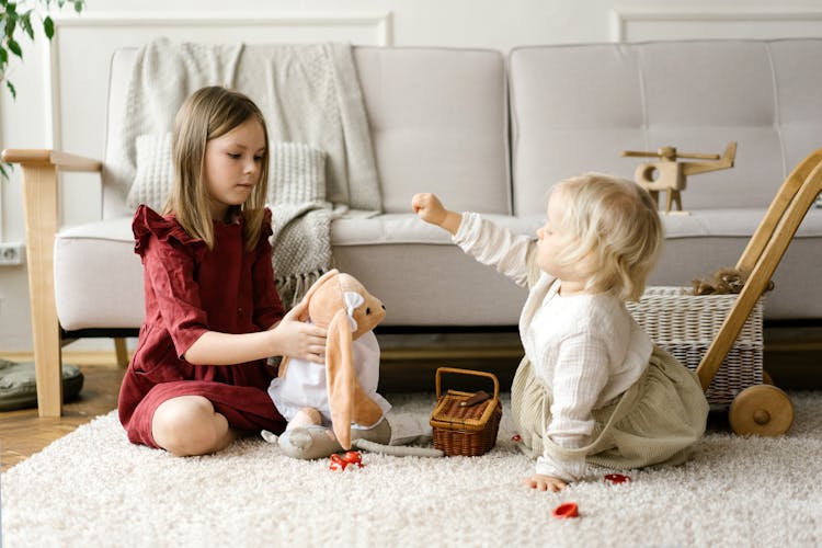 Children Sitting On Carpet While Playing