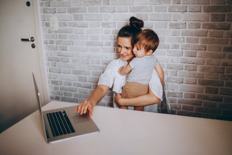 Happy Mother With Little Son Using Laptop