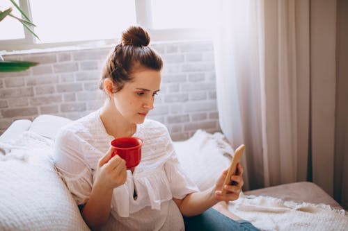 Free Woman Browsing on her Phone Stock Photo