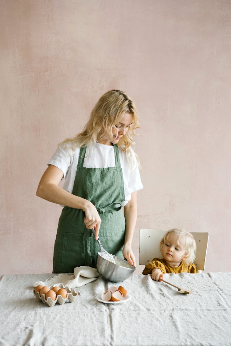 A Mother And Her Daughter Baking Together