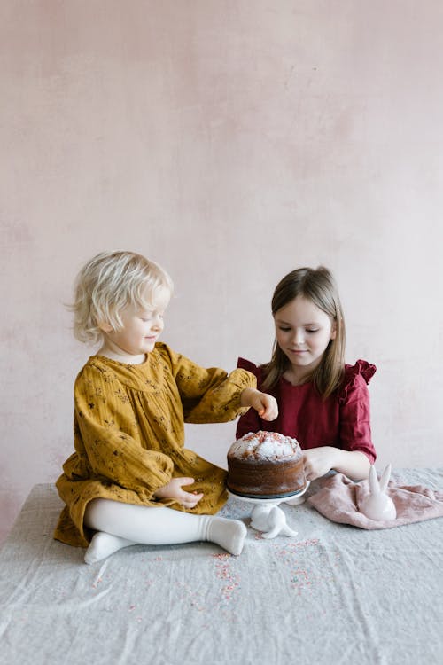 Photograph of Girls Near a Cake