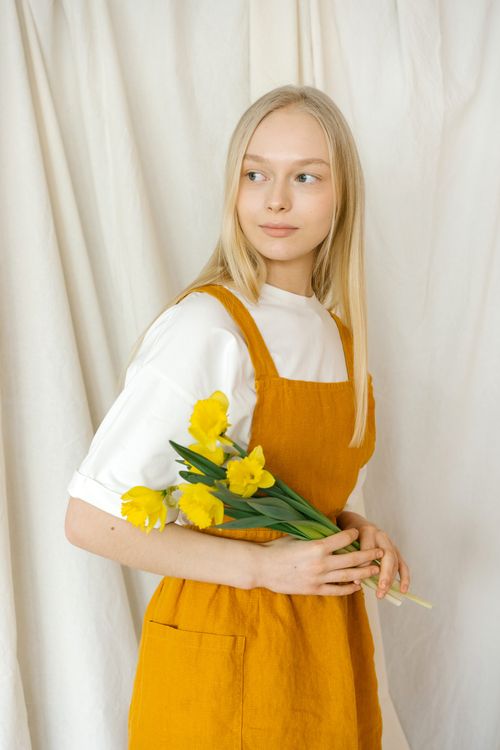 A Woman in White Shirt Wearing Yellow Apron · Free Stock Photo