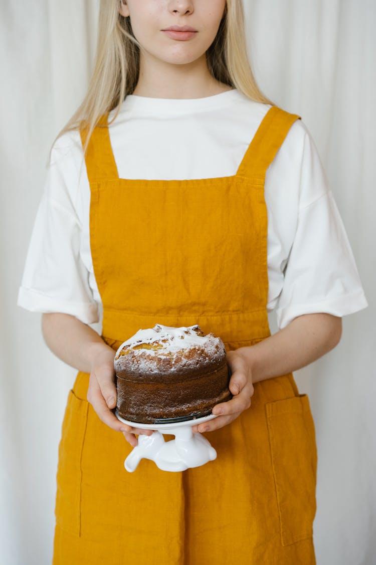 Woman In A White Shirt Holding A Cake