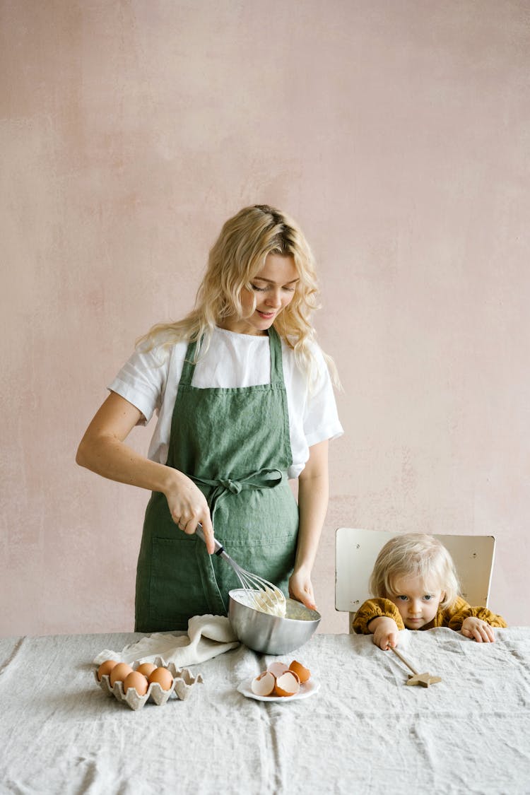 A Woman Baking Beside Her Daughter