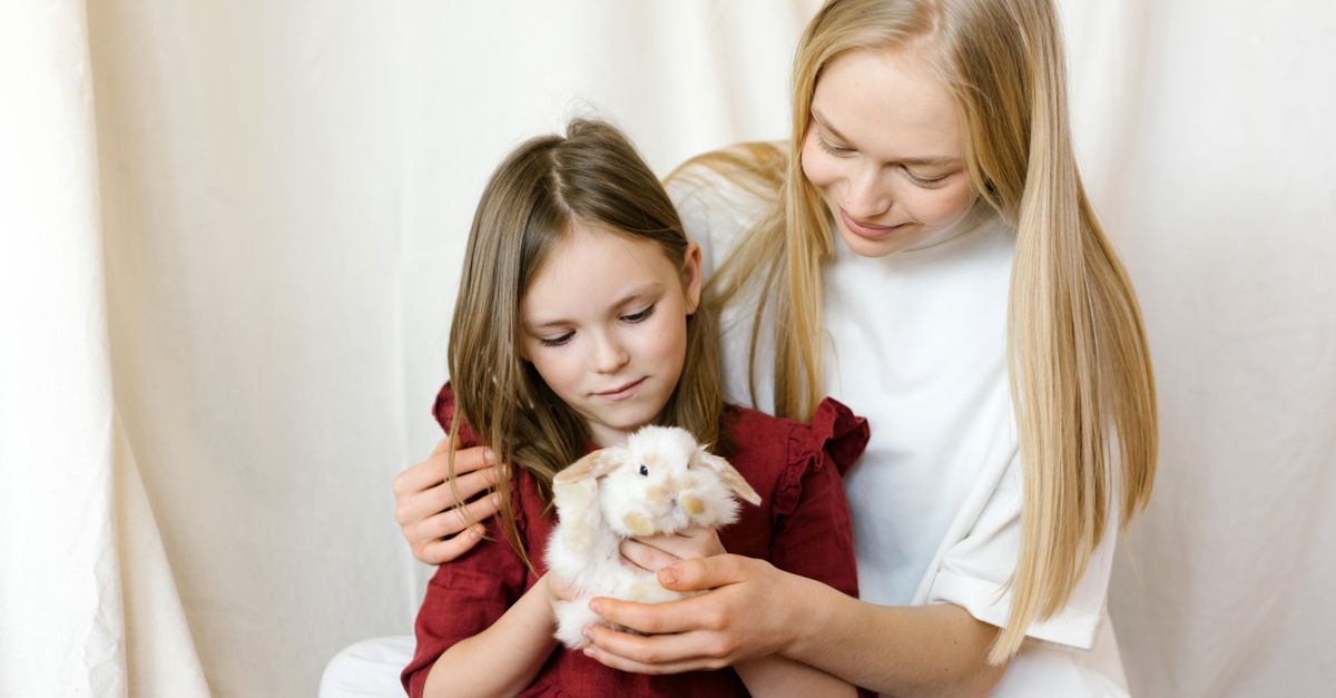 Choosing a Pet for Kids Best pets for kids: a mother and young daughter gently holding a pet rabbit together