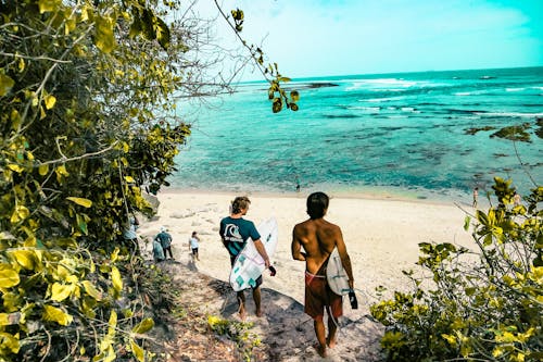 Dwóch Mężczyzn Posiadających Deski Surfingowe Na Plażę