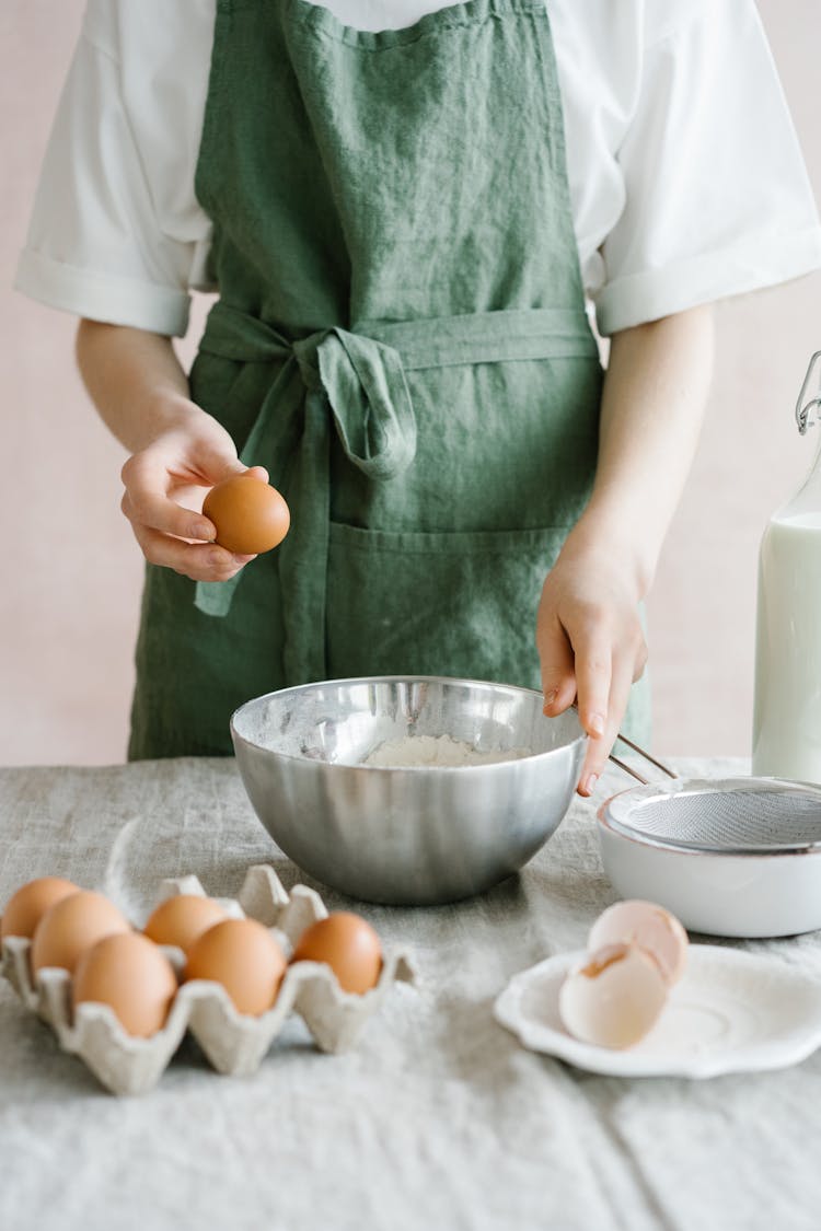 A Person Holding An Organic Egg And A Baking Bowl