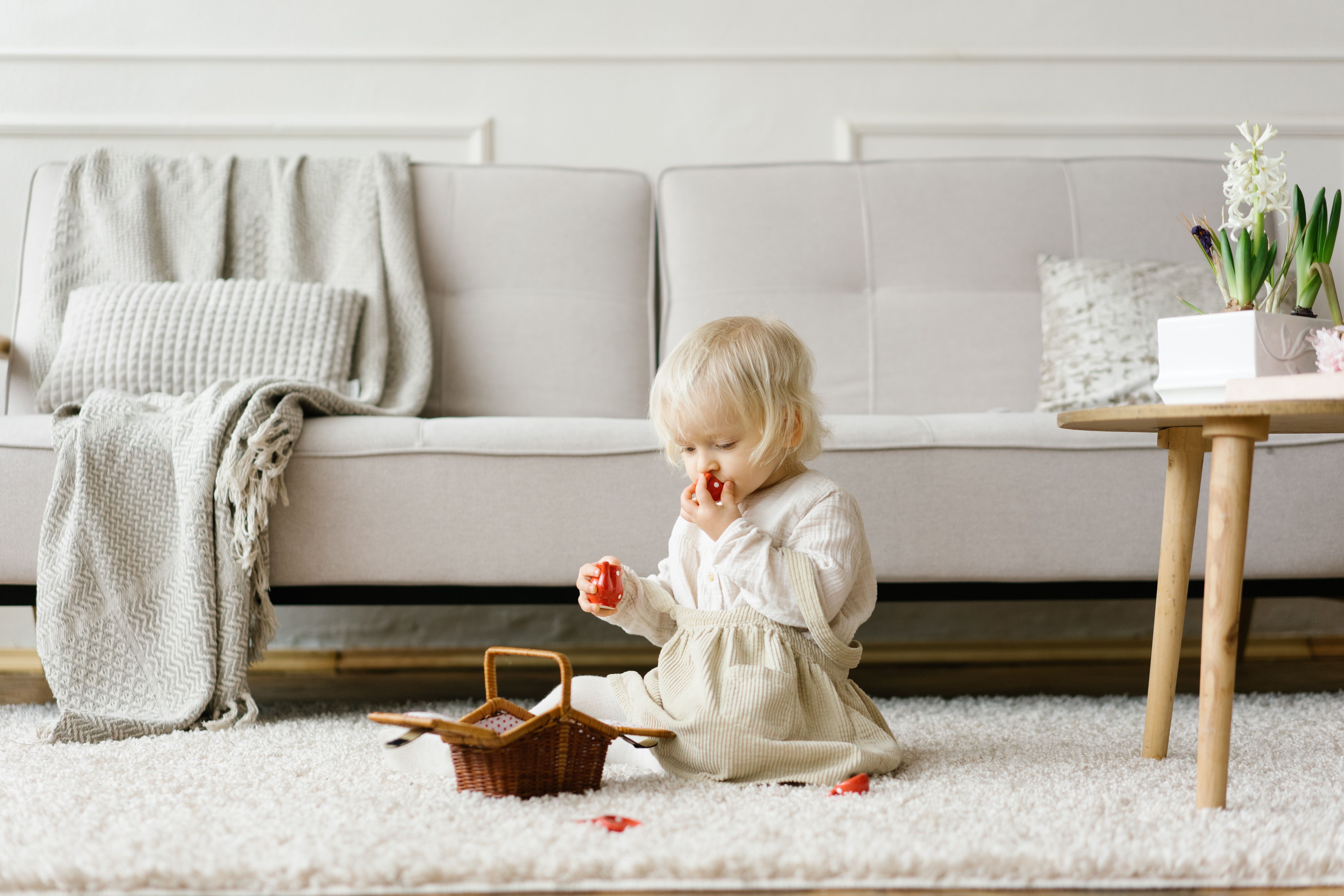 Little girl sitting on floor in living room · Free Stock Photo