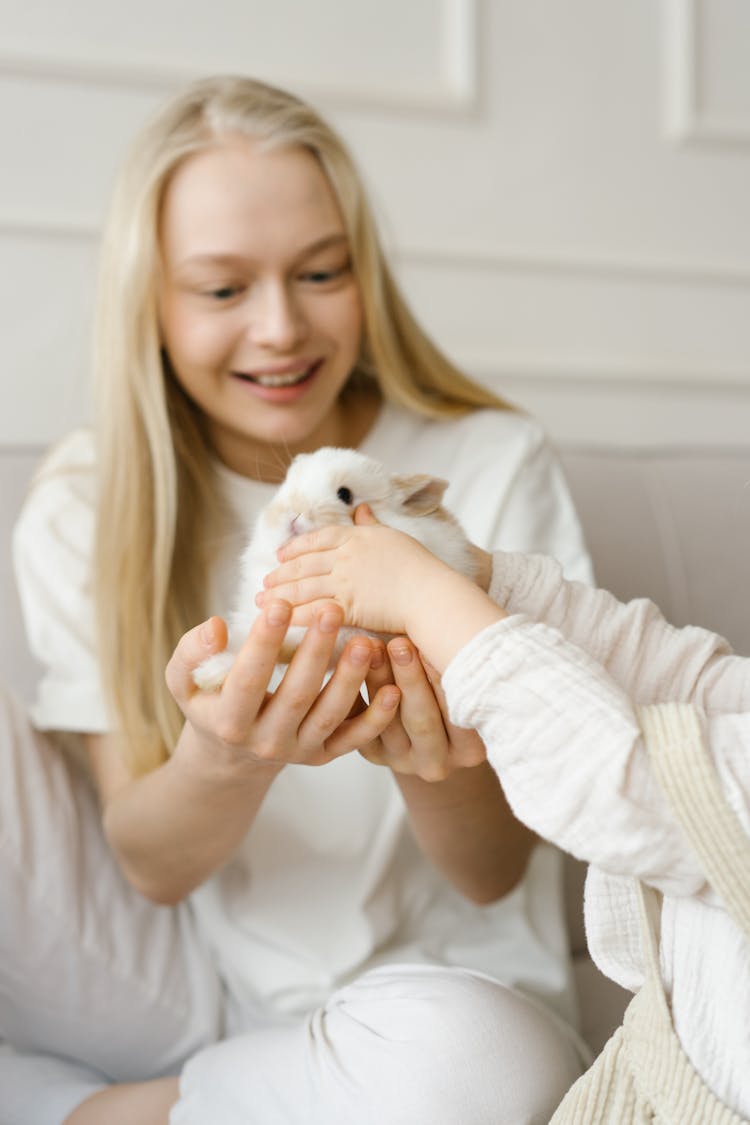 Happy Girl Receiving A Rabbit 