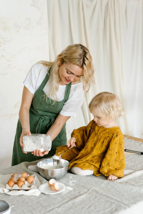 Free Woman and Child Mixing Flour in a Bowl  Stock Photo