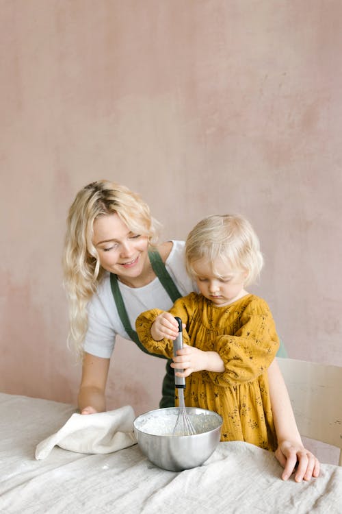 Free A Young Girl Holding Silver Whisk Stock Photo
