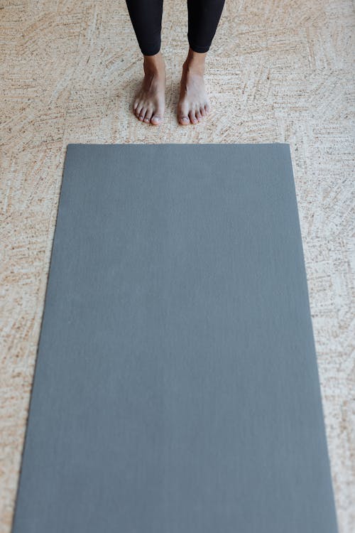 Person Standing on Gray Rug