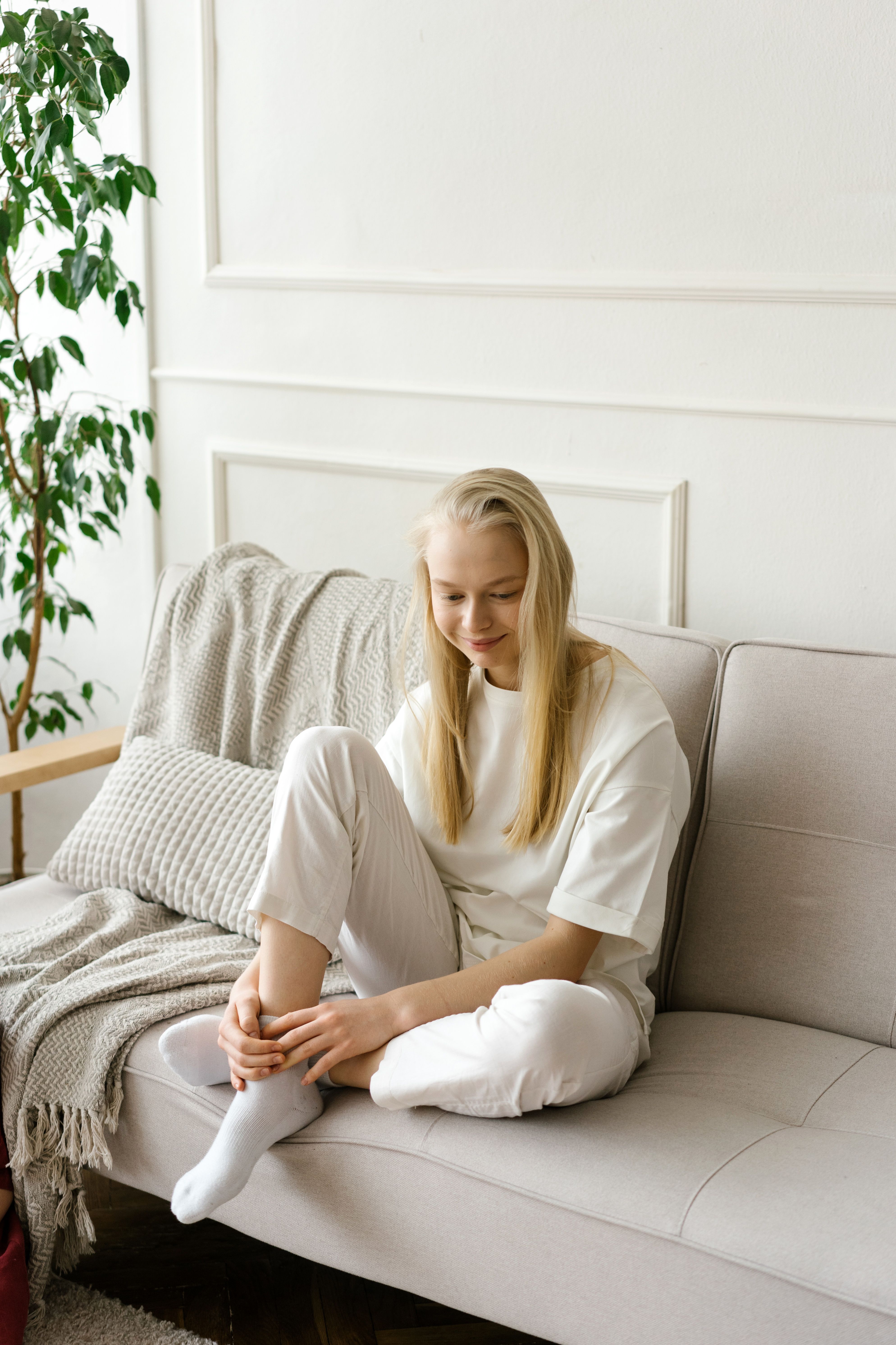 A woman resting peacefully in a bright, cozy room
