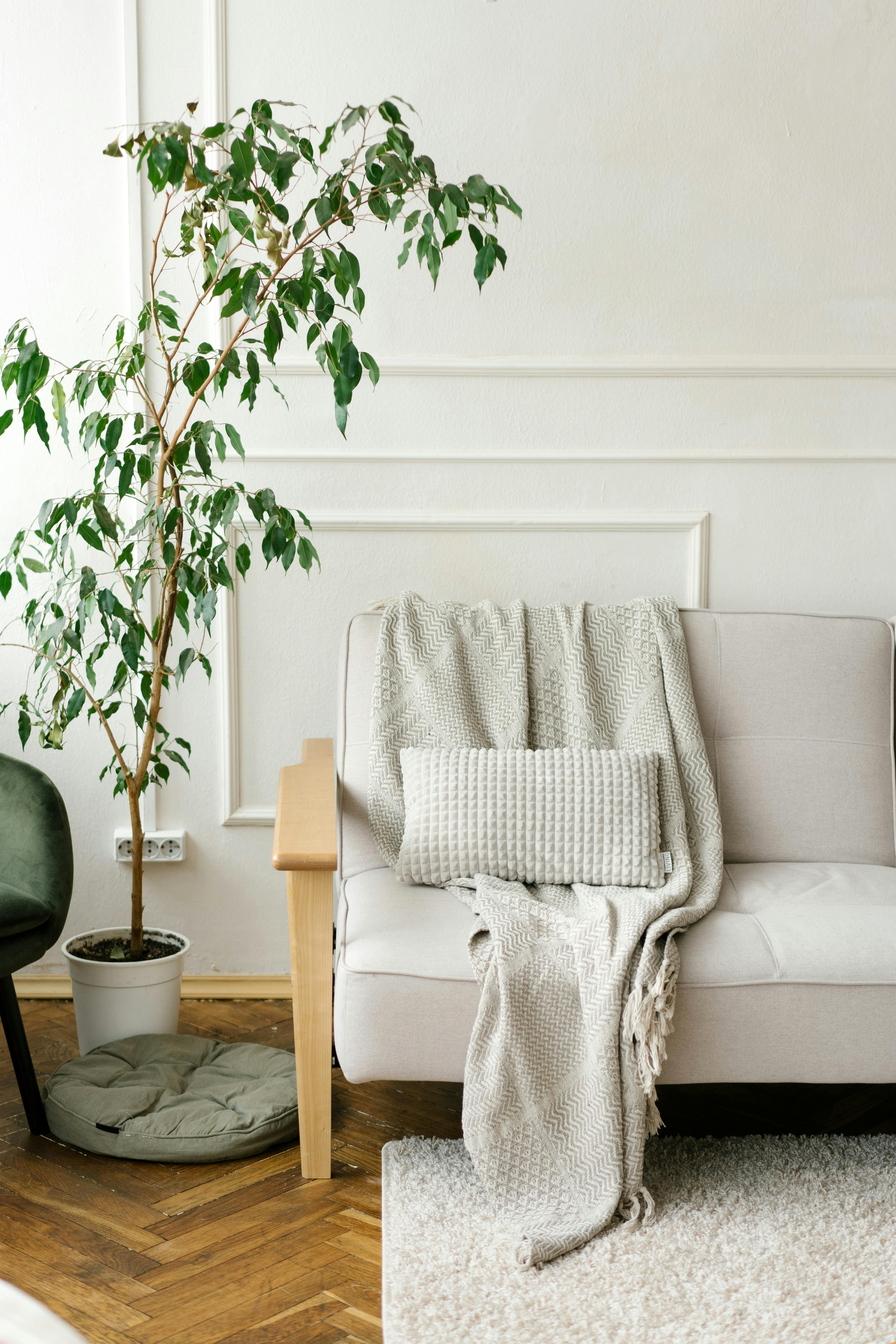 Close Up Photograph of Sofa Chair Near Round Ottoman · Free Stock Photo