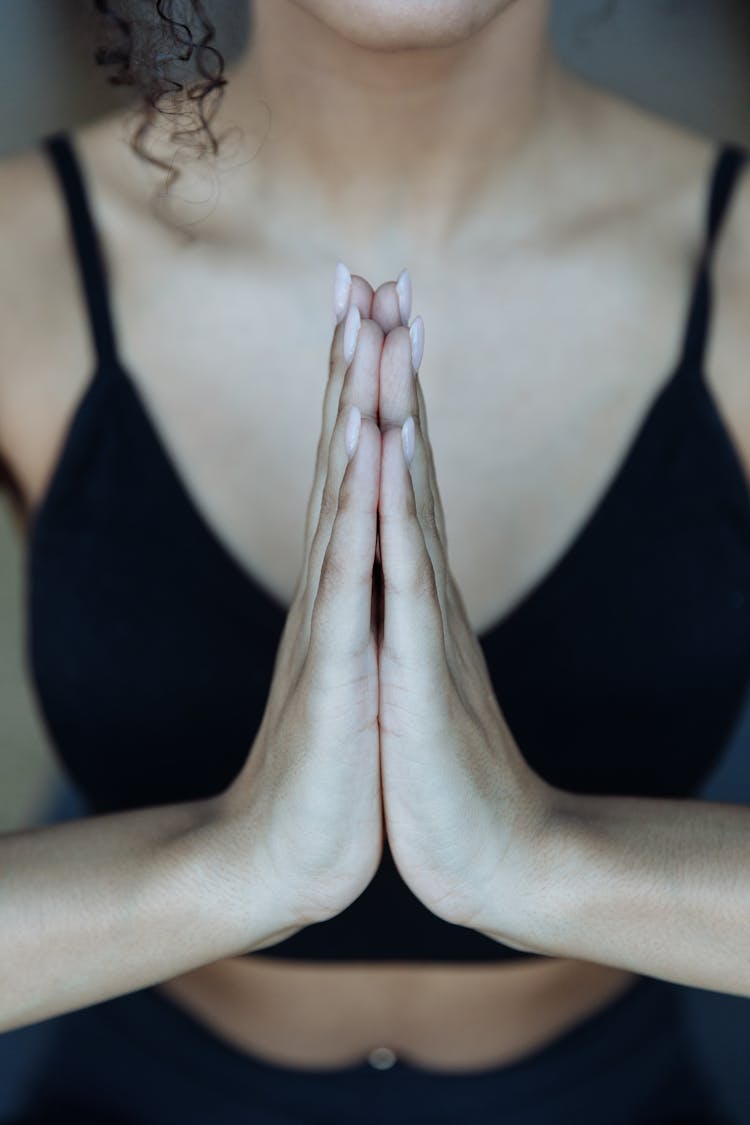 Close-up Shot Of Woman In Black Brassiere Praying