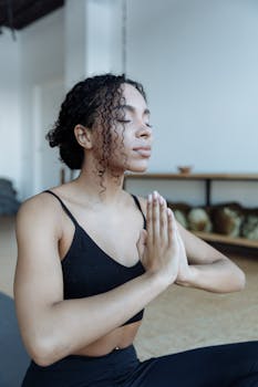 Serene moment of meditation captured indoors with soft light, emphasizing mindfulness and inner peace.