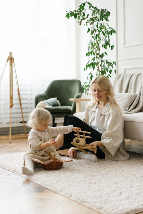 Free Cute little girl playing toys with mother Stock Photo