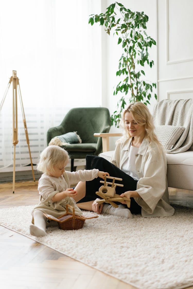 Cute Little Girl Playing Toys With Mother