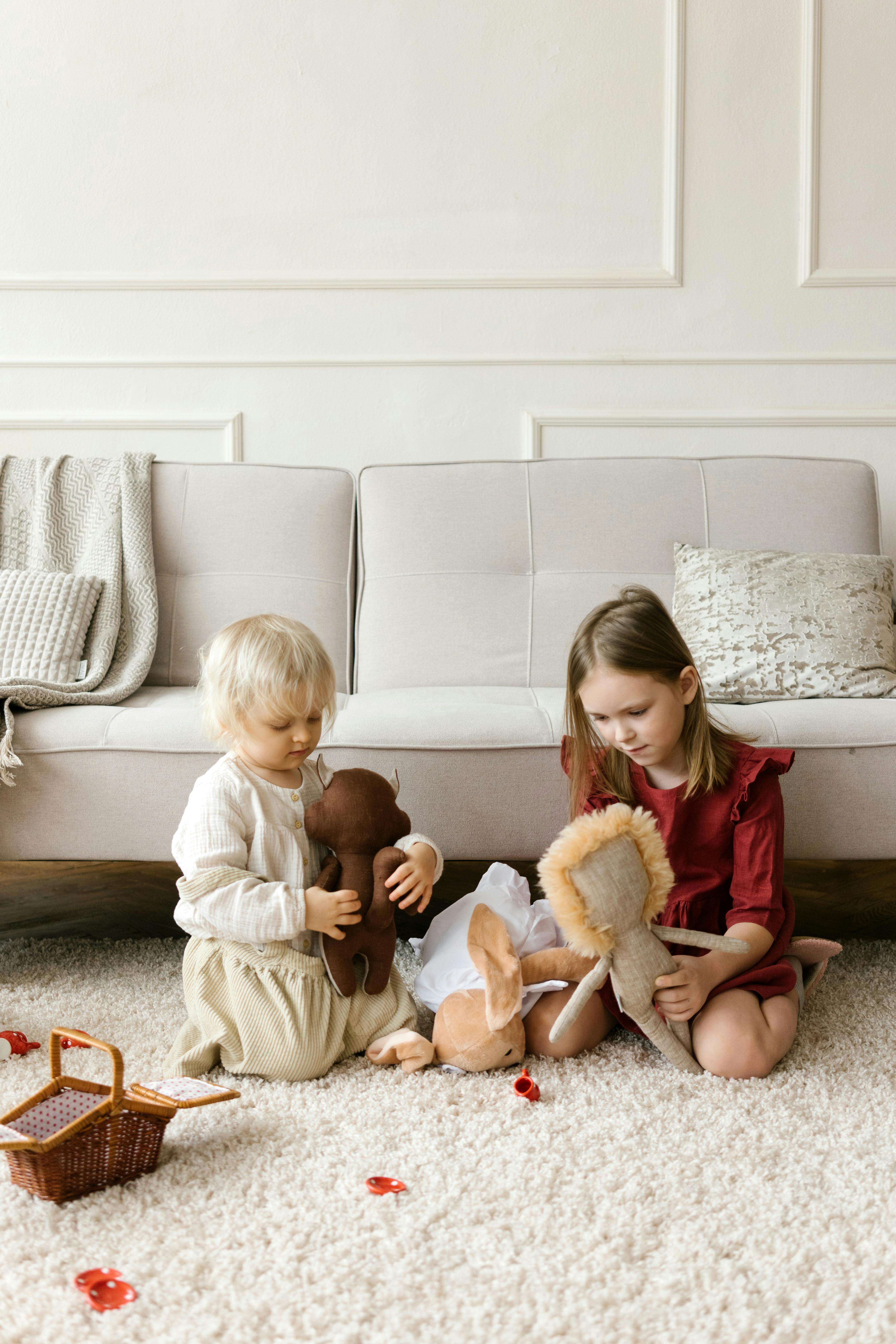 little girls playing with toys in room