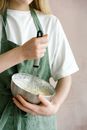 Female mixing ingredients in bowl with whisk