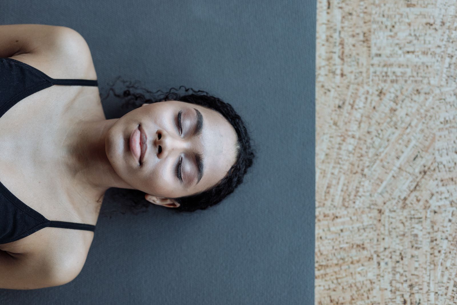 Woman practicing seated yoga stretch with calm expression and glowing skin