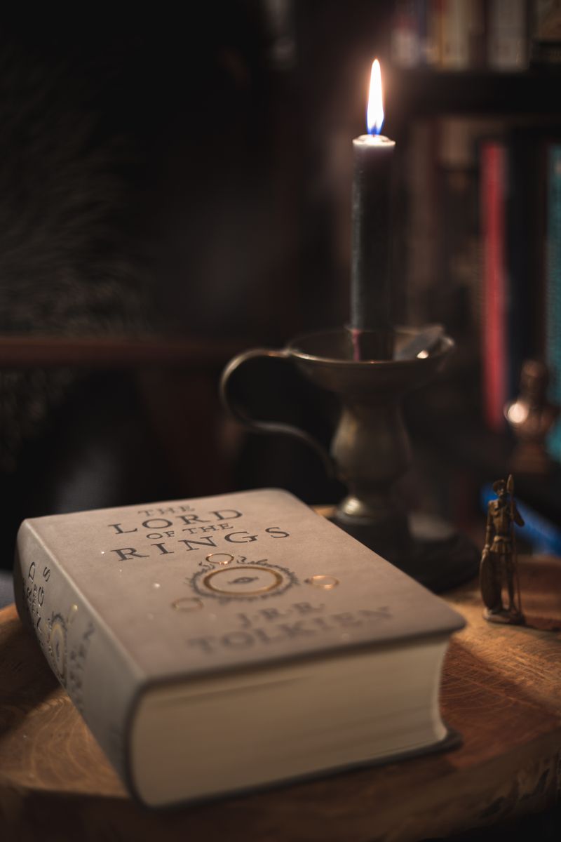 Cozy candlelit setting with The Lord of the Rings book