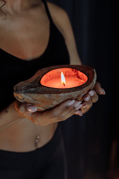 Free Close-Up Photo of a Woman's Hands Holding a Lit Candle Stock Photo