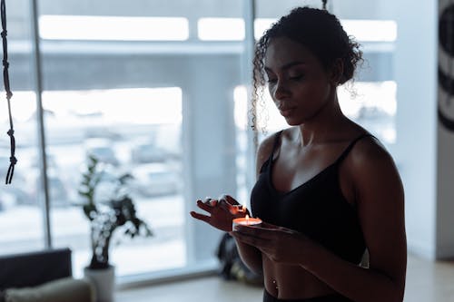 A Woman Holding a Lit Candle