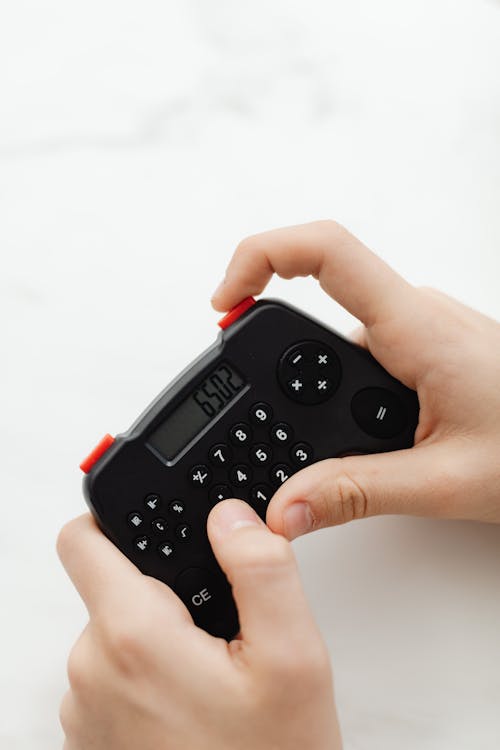 Person Holding A Black Portable Controller
