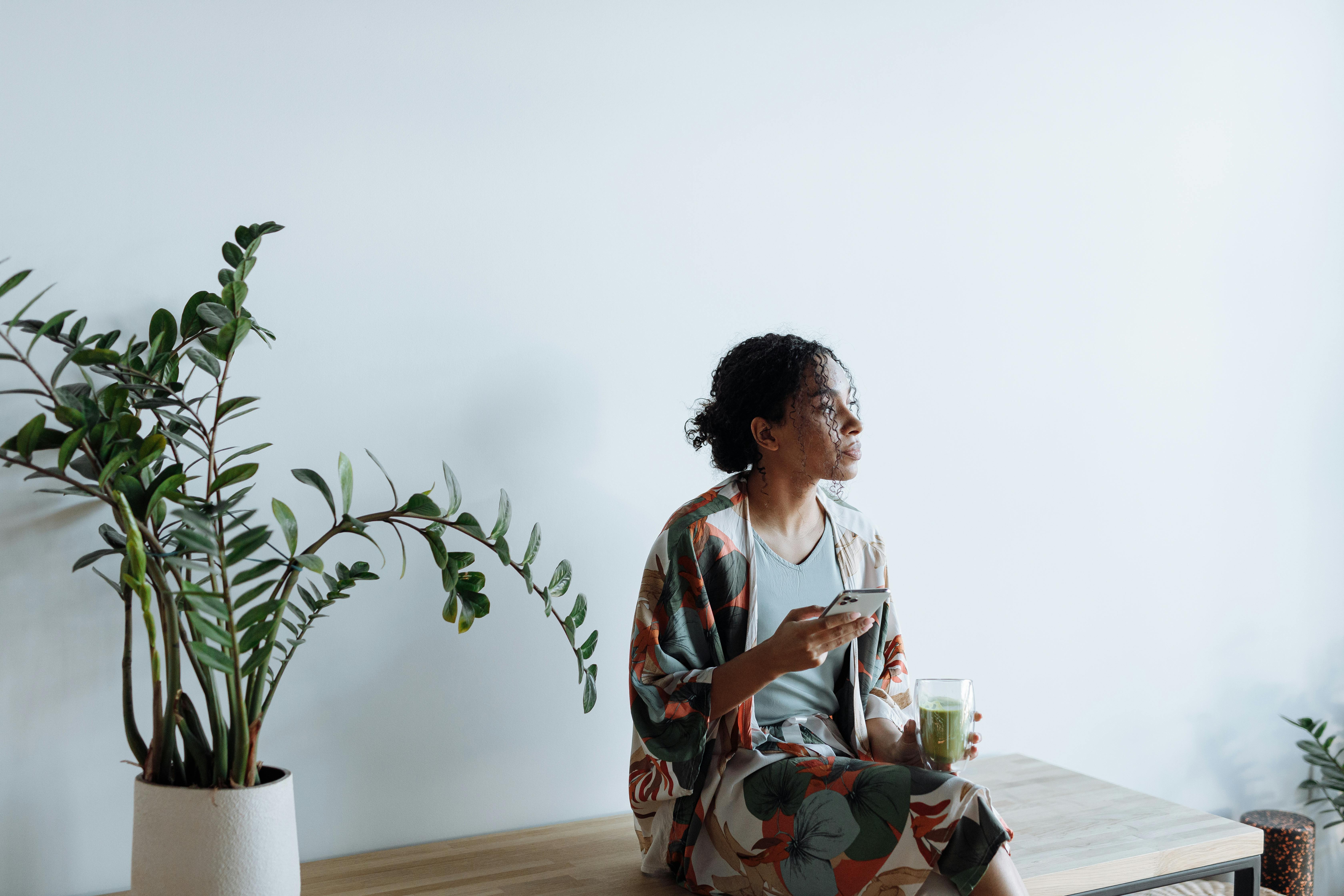Woman in White and Red Floral Dress Sitting on Chair