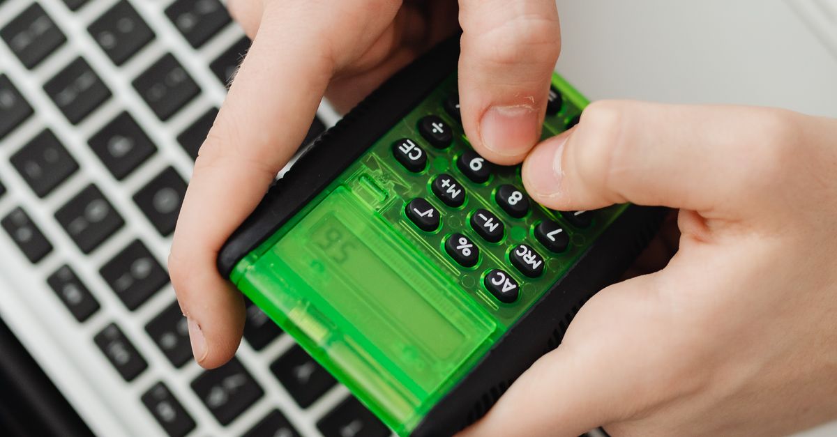 Using Calculator Image A Person using a Calculator · Free Stock Photo