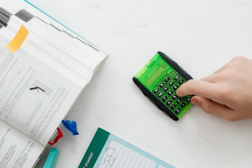 Person Using A Green and Black Calculator