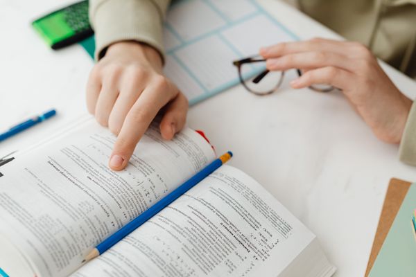 Close-up of a student reviewing a workbook