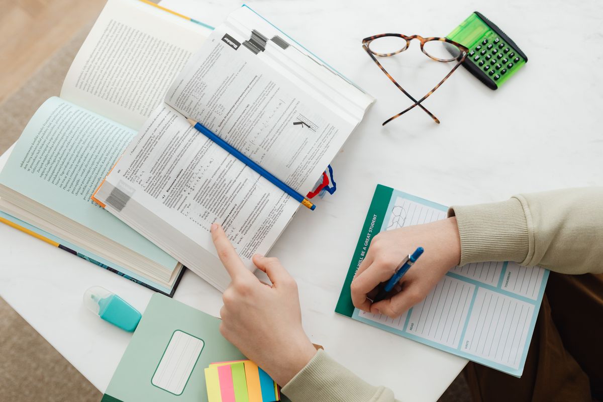 Books, notes and a calculator arranged for focused exam preparation