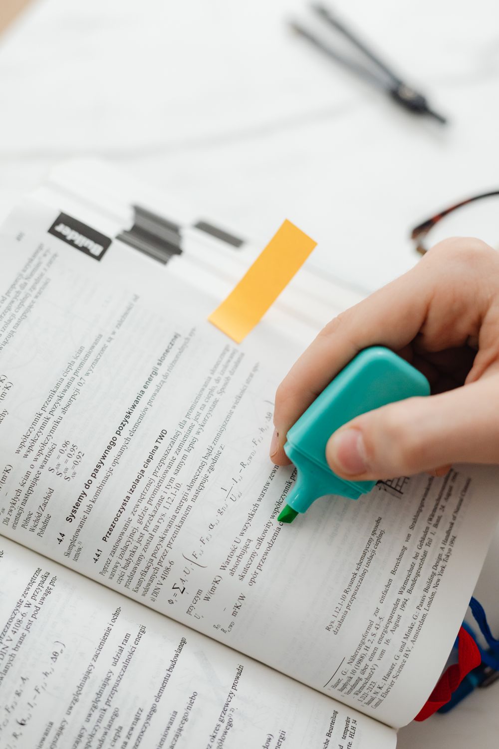Highlighter In Book Person Using Blue Highlighter Pen On A Book Page · Free Stock Photo