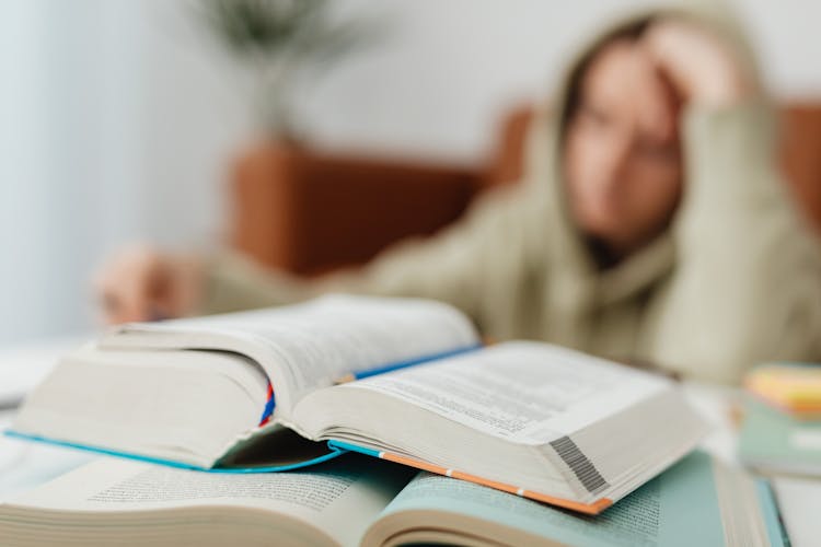 Books On Tired Student Desk