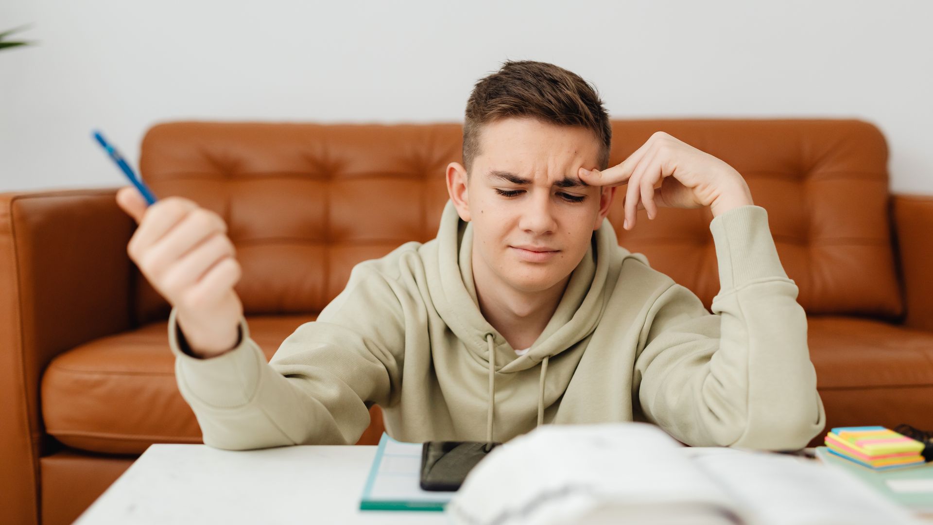 How to Increase Focus for Studying: Proven Strategies for Success Teen boy concentrating on homework, looking stressed and thoughtful in a cozy indoor setting — how to increase focus for studying