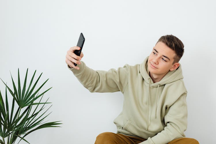 Teenager Taking A Picture Of Himself 