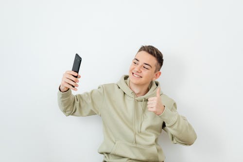 Free A Man Taking a Selfie with a Thumbs Up Stock Photo