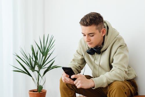 Man Sitting with Cellphone