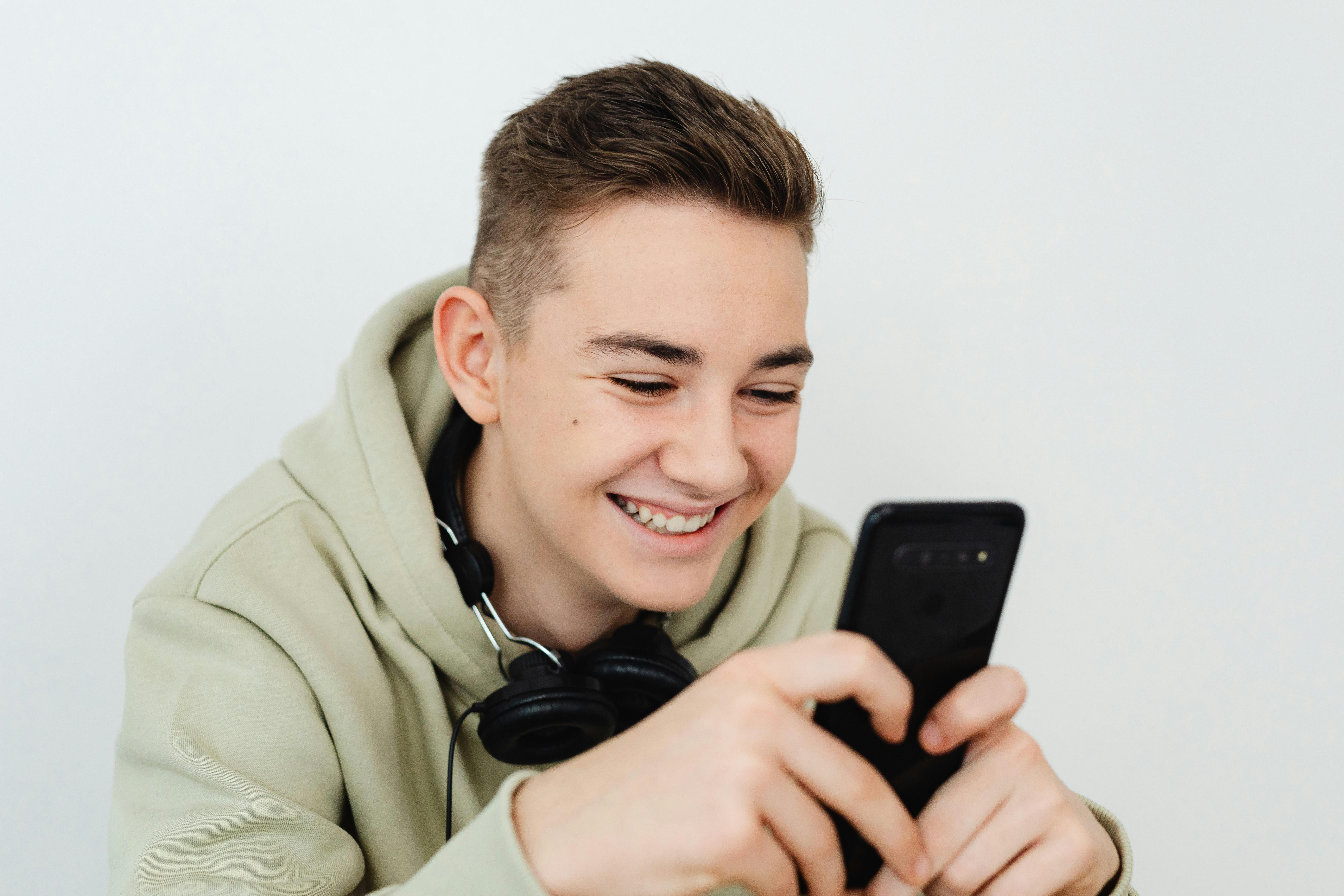 a man holding a smartphone smiling