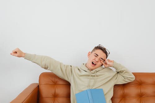 Free Man Stretching Arm and Yawning Stock Photo